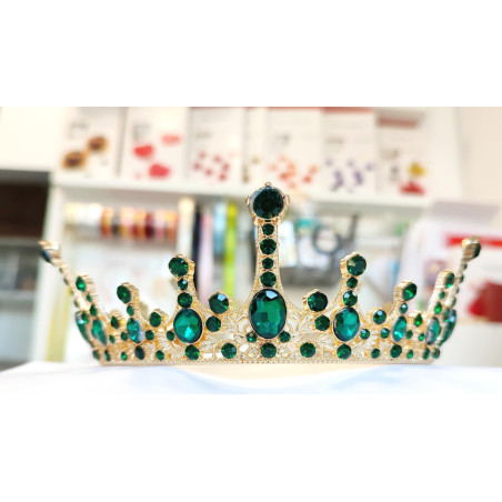 Large golden crown with multiple green gems