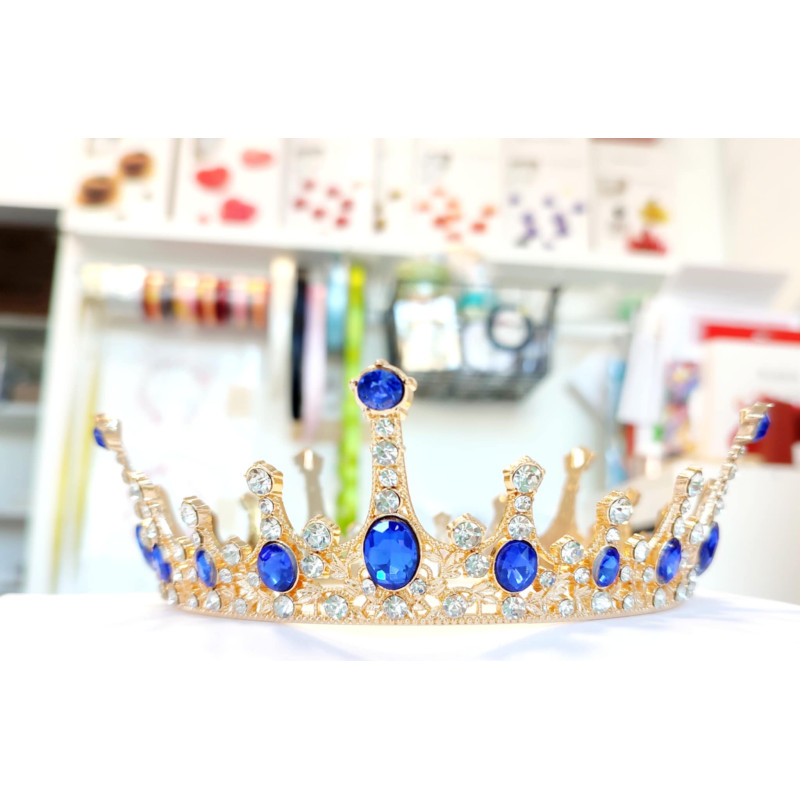 Large golden crown with multiple blue gems