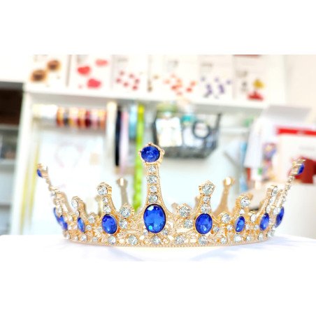 Large golden crown with multiple blue gems
