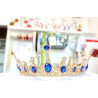 Large golden crown with multiple blue gems